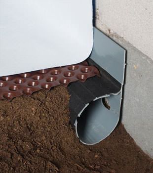 Closeup of a crawl space drainage system installed in Edwards