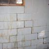 A cracked foundation wall near a window in a Cumberland home
