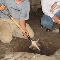 Digging a hole for the engineered fill used in a crawl space support system installation in Smiths Falls