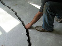 a severely damaged cracked concrete slab floor in Winchester