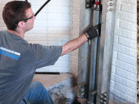 Driving foundation piers into the floor in Perth.