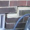 A closeup of a failed tuckpointing job where the brick cracked on a Lancaster home.