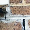 Failed crack repair showing old tuckpointing that cracked on a Orleans home.
