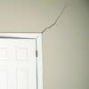 A long drywall crack beginning at the corner of a doorway in a Winchester home.