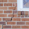 long jagged cracks starting at the corner of a window along a brick wall on a Prescott home
