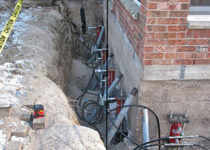Foundation push piers installed around a house with a foundation settlement issues in Edwards