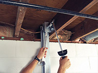 Straightening a foundation wall with the PowerBrace™ i-beam system in a Renfrew home.