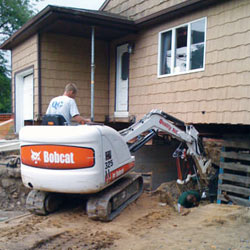 Excavating to expose the foundation walls and footings for a replacement job in Perth
