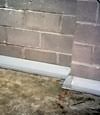 Our baseboard drain system installed on a corner in a Vanier basement.
