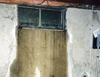 Water pouring out from a basement window in Gloucester